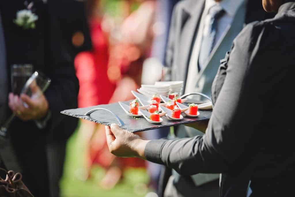 Server with a tray of appetizers