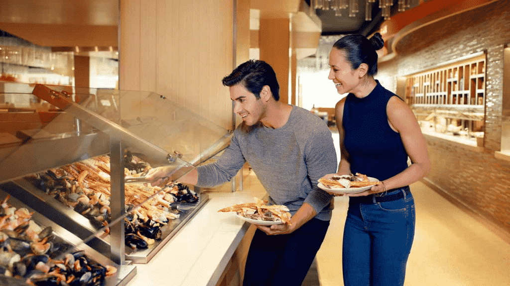 A couple making their plates at The Aria Buffet. 