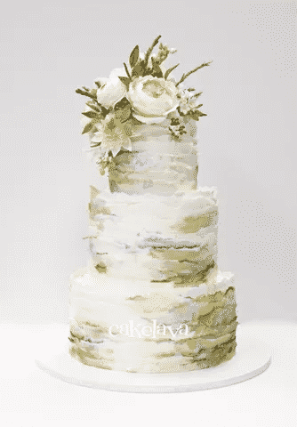 A colorful wedding cake topped with white flowers.